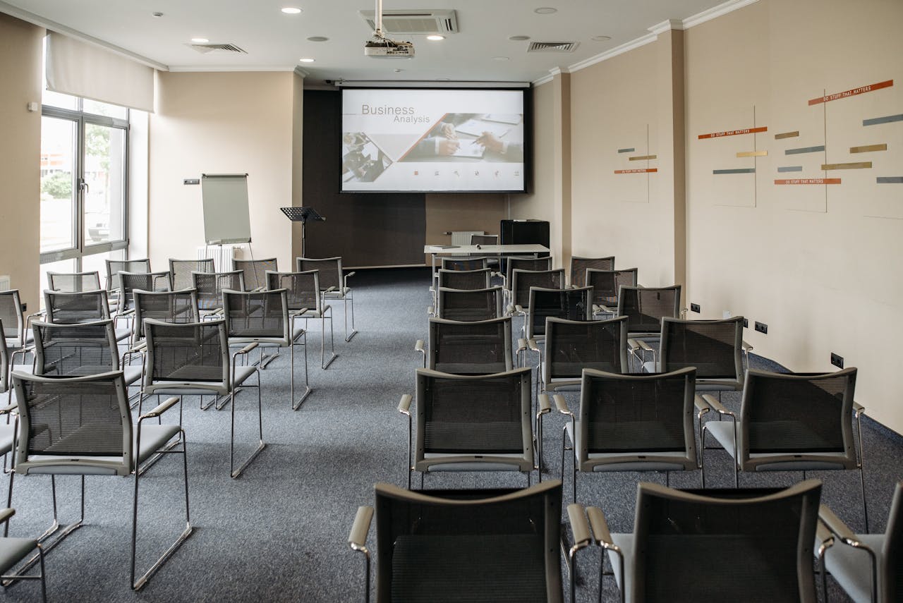 gallery-04 Empty conference room with chairs and a presentation screen setup for business meetings.